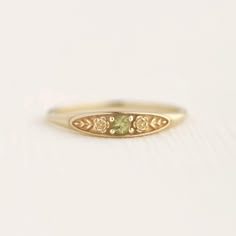 August birth ring This ring will be a very meaningful piece for those born in August . August's birthstone and birth flower are Peridot and Poppy. Greeny peridot and delicately carved poppy will shine and bloom forever. This dainty and slim signet ring is comfortable to wear all the time. This piece will be perfect gift for both to others and yourself. * Detail * Material : 14K solid gold, 18K solid gold, 925 sterling silver Color : Yellow gold, White gold or Rose gold(925 sterling silver is excluded) Stone : Natural Peridot(2.5mm) * Size * Top width : 3.7mm Shank width : 1.2mm Band depth : 2.4-0.9mm * Please check your ring size before ordering, Use this : http://www.onlineconversion.com/ring_size.htm We provide special package with some our business card, guarantee card, gift box. Please Subtle Promise Rings, Emerald Heirloom Ring, Silver Rings With Diamonds, Boho Promise Ring, Metal Work Rings, Gold Floral Ring, Grad Rings College, Cute Class Rings, Good Rings Women