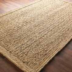 an area rug on the floor with wooden floors and hard wood planks in the background