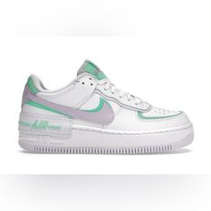 The Nike Af1 Shadow Stands Out Because Of Its Two Eyestays, Two Mudguards, Two Back Tabs, And Two Swoosh Designs In Green And Purple. Then, They Follow The Classic Design Of The Shoe With White Leather Construction And A White Rubber Sole. Nike White Custom Athleisure Sneakers, Nike White Custom Sneakers For Athleisure, Nike Air Force 1 White With Translucent Outsole, White Nike Air Force 1 With Translucent Outsole, Nike Air Force 1 With Translucent Outsole For Sports, Nike Air Force 1 Casual With Translucent Outsole, White High-top Nike Air Force 1 With Translucent Outsole, Casual Nike Air Force 1 With Translucent Outsole, White Custom Athleisure Sneakers With Air Max Cushioning