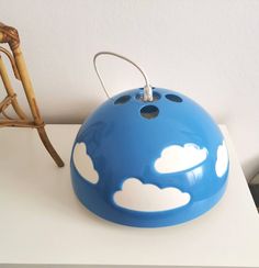 a blue and white lamp sitting on top of a table