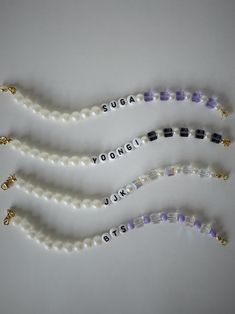 three beaded necklaces with words written on them