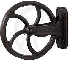 an old fashioned cast iron wall hook with the words rustic state on it's side