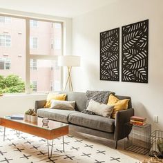 a living room filled with furniture and large windows