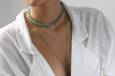 Experience the serene elegance of our Green Aventurine Beaded Necklace. Centered with a dainty Cubic Zirconia charm, this piece encapsulates subtle luxury. The necklace is secured with a gold clasp, offering both sophistication and durability. Customize the length to fit your unique style and make it a versatile addition to your jewelry collection. Whether it's a personal treat or a thoughtful gift, this necklace is an embodiment of grace and craftsmanship. Serene Green Aventurine Dainty Cubic Z Subtle Luxury, Green Aventurine, Versatile Style, Metal Stamping, Gold Vermeil, Round Shape, Natural Stone, Thoughtful Gifts, Make It