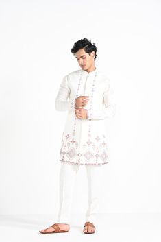 Ivory Phulkari inspired Nehru Jacket with pipe, cutdaana and thread work embroidery with same coloured kurta with embroidery detail on the chest and sleeve. this set in made in linen Satin, Paired with Ivory slim fit Pant Pajama. Color of
the actual garment may vary due to lighting conditions during the shoot.

Size Chart For Men





	
	
					Men's Size Chart
		

		
		
						
				Size Chart For Men
				Custom Size Measurement Guide
			
			
				
				
				Custom Size Measurement Guide
1. Take you Designer Floral Embroidered Kurta For Transitional Season, Designer Floral Embroidery Kurta For Transitional Season, Transitional Off-white Sets With Floral Embroidery, Traditional Drape Nehru Jacket With Floral Embroidery, Traditional Drape Kurta With Floral Embroidery For Eid, Floral Embroidered Kurta With Traditional Drape For Eid, Floral Embroidered Kurta For Eid With Traditional Drape, Floral Embroidery Kurta With Traditional Drape For Eid, Floral Embroidered Kurta For Eid