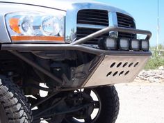 the front end of a pickup truck with its bumper mounted on it's tires