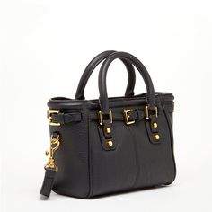 a black leather handbag with gold hardwares on the handles and shoulder strap is shown