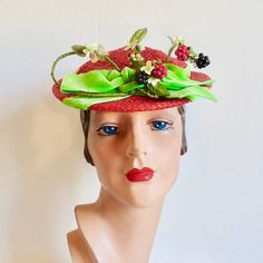 "A very whimsical hat from the 1950's from a well known Hollywood milliner. Made in a red woven synthetic straw. Shallow crown and a small brim. Adorned with faux blackberries, rasberries, and yellow berries as well as small yellow fabric flowers, stems and leaves. Also trimmed with a lime green velvet ribbon around the crown and a bow at the front. Interior hat has a green velvet head holder that anchors to the back of the head. Red grosgrain ribbon trims the inside crown. Label:  Caspar Davis Green Velvet Ribbon, Large Brim Hat, Types Of Hats, Hat Fascinator, Back Of The Head, Brim Hats, Hollywood Fashion, Yellow Fabric, Cute Hats