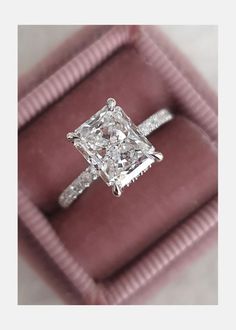 a princess cut diamond ring in a velvet box