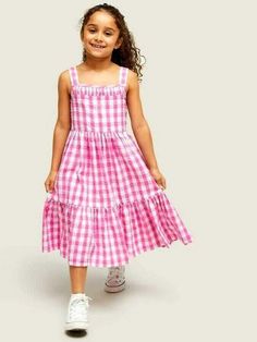 Decorated in all-over checks, this tiered dress from our own collection is made from pure cotton that's soft against little one's skin. Fully lined for ultimate comfort, it's defined by smocked back detailing and a flared bottom tier. Pair with pumps for the perfect look. Details: 100% Cotton Summer Plaid Smocked Dress With Ruffles, Playful Cotton Smocked Dress For Spring, Cotton Tiered Dress With Smocked Bodice, Spring Cotton Smocked Tiered Dress, Spring Cotton Tiered Smocked Dress, Plaid Cotton Tiered Dress, Spring Tiered Cotton Smocked Dress, Cute Gingham Smocked Dress With Ruffles, Casual Gingham Tiered Dress