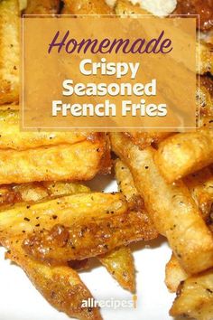 homemade crispy seasoned french fries on a white plate with text overlay that reads homemade crispy seasoned french fries