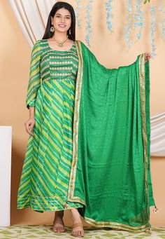 Pure Kota Silk and Art Silk Anarkali Kameez in Green Color. This Readymade Round Neck and Quarter Sleeve attire with Shantoon Lining is Enhanced with Leheriya Print, Zari ,Sequins and Gota Lace Work. Available with a Shantoon Churidar in Green and a Fancy Lace Border Faux Crepe Jacquard Dupatta in Green Color. The Kameez and Bottom Lengths are 52 inches respectively.   Do note: 1.)Accessories shown in the image are for presentation purposes only and length may vary up to 2 inches. 2.)Slight vari Festive Anarkali Set With Dupatta For Diwali, Green Maxi Length Traditional Wear With Cutdana, Green Cutdana Anarkali Set For Navratri, Anarkali Salwar Kameez With Dupatta For Festive Occasions, Traditional Green Floor-length Palazzo Set, Anarkali Sharara With Dupatta For Festive Occasions, Festive Navratri Chinon Anarkali Set, Green Floor-length Kurta With Cutdana Detail, Green Floor-length Kurta With Cutdana