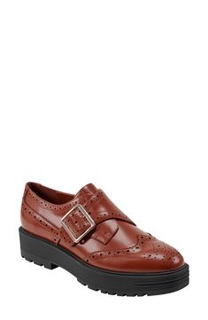 Brogue perforations and wingtip styling add timeless elements to a lofty platform loafer fashioned with an adjustable monk strap for a secure fit. 1 1/2" heel; 1" platform Adjustable monk strap with buckle closure Leather upper/synthetic lining and sole Imported Fall Office Wingtip Platform Loafers, Fall Business Wingtip Platform Loafers, Elegant Wingtip Platform Oxfords, Leather Wingtip Platform Loafers With Brogue Detailing, Formal Wingtip Platform Loafers With Brogue Detailing, Wingtip Platform Loafers With Lug Sole For Work, Fall Monk Strap Shoes With Brogue Detailing, Fall Monk Strap Shoes With Brogue Detailing And Wingtip, Brown Wingtip Platform Loafers With Brogue Detailing