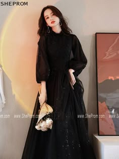 Buy Modest Black Long Tulle Formal Dress with Long Lantern Sleeves id#AM6097 at SheProm. SheProm.com is an online store with thousands of formal dresses. Shop 100% authentic prom dresses with free standard shipping. Black Tulle Dress Long Sleeve, Classy Modest Dresses Formal, Long Black Dress With Long Sleeves, Beautiful Dresses For Birthday, Black Formal Dress Elegant, Black Dresses For Birthday, Black Prom Dress With Sleeves, Black Prom Dress Modest, Long Sleeve Prom Dress Modest