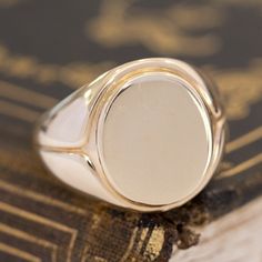 This vintage signet ring from the famed house Tiffany & Co. is big, bold, and gold - three of our favorite things here at JbyG. The 14kt gold is such a warm and buttery tone, and when worn, the ring feels like armor on the finger! The top of the ring is blank and ready to be engraved with a message or image of your choosing - or leave her blank and let your daily life leave its mark! 14kt Yellow Gold Size 9.75 & fully resizable Please see qualitative report for more information. Classic Hallmarked Signet Ring For Collectors, Classic Hallmarked Signet Ring Collectible, Gold Signet Ring With Polished Finish For Collectors, Classic Oval Signet Ring Collectible, Antique Gold Dome Ring With Polished Finish, Classic Domed Collectible Jewelry, Classic White Gold Signet Ring Collectible, Antique Oval Signet Ring With Polished Finish, Timeless Gold Signet Ring