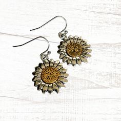 Stunning silver and gold tone sunflower drop earrings will go with everything and any occassion. Dimensional charms feature antique silver flower petals with a lovely gold tone center. Very pretty and unusual, these artisan handmade earrings will go with all your silver or gold jewelry and look great when worn alone. Ear wires are hypoallergenic, nickel and lead free. Choose your ear wire style at checkout. Free gift packaging included. Earrings are carded and in an organza bag. Link back to my shop: https://www.etsy.com/shop/JezaJewelry Mixed Metal Sunflower Charm Earrings - Gold and Silver Drops - Handmade Jewelry Gift for Her Silver Flower-shaped Brass Earrings, Adjustable Gold Sunflower Jewelry, Adjustable Gold Jewelry With Sunflower Design, Vintage Gold Jewelry With Sunflower Design, Anniversary Gold Jewelry With Sunflower Design, Vintage Nickel Free Metal Flower Earrings, Silver Brass Flower-shaped Earrings, Gold Sunflower Dangle Jewelry, Vintage Nickel-free Metal Flower Earrings