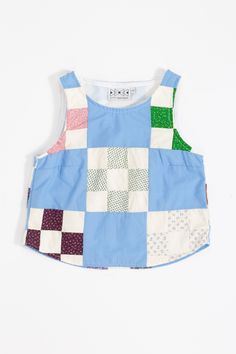 a child's blue and white patchwork top