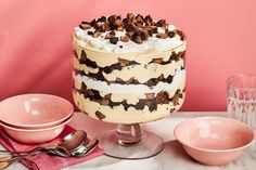 a cake sitting on top of a table next to bowls