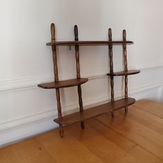 a wooden shelf with two shelves on each side