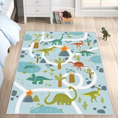 a child's bedroom area rug with dinosaurs and plants on the floor, along with toys