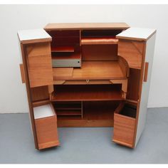 an open wooden cabinet with drawers and shelves