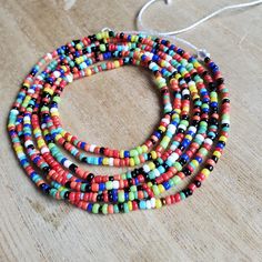 This colorful waistbead was made with multicolored glass seed beads.Waistbead length: 50 inches Strung on strong, cotton cord with 2 clear anchor beads (for adjustment) and 2 knots. Tie on, permanent waistbeads. Waist beads have been worn for centuries in African tradition, and the uses are endless. From adornment and weight management, all the way to signs of maturity and femininity, the diversity of waist beads make them appealing pieces of jewelry to own. They are generally worn under a garme Signs Of Maturity, Wire Projects, African Traditions, Waist Beads, Memory Wire, Glass Seed Beads, Cotton Cord, Weight Management, How To Make Beads