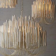 a chandelier made out of wooden sticks hanging from the ceiling in a room