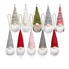 a group of christmas gnome ornaments hanging from hooks