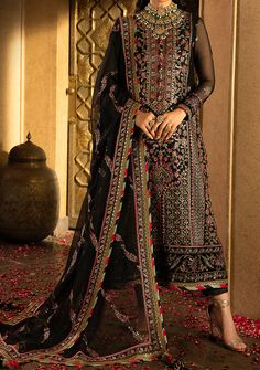 Introducing our Winter collection 'VELVET FESTIVE' by Asim Jofa designed to make you look and feel your best these pieces will add a touch of class and elegance to your wardrobe. In a captivating dance of colors and motifs, this onyx elite ensemble unfolds like a love story waiting to be told. It's a masterpiece embroidered with intricate motifs, where threads of gold are echoing the ancient art of Meenakari. These motifs breathe life into the attire, a tribute to the rich flora and fauna of South Asia, painting a vivid picture of nature's abundance. The shirt and dupatta, born of the same fabric, share a secret world adorned with delicate cupped sequins, zari, and threads in the hues of magenta and green. The borders of the hem, sleeves, and shirt, cloaked in sumptuous velvet, bring an el Semi-stitched Long Georgette Churidar, Bollywood Georgette Unstitched Suit For Festivals, Festival Georgette Salwar Kameez With Resham Embroidery, Semi-stitched Georgette Churidar For Festivals, Unstitched Bollywood Style Georgette Salwar Kameez, Unstitched Georgette Churidar For Festivals, Festival Unstitched Georgette Churidar, Long Georgette Dupatta, Bollywood Style Designer Georgette Salwar Kameez