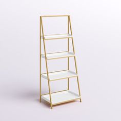 a gold and white shelf with three shelves on each side, against a gray background