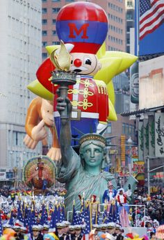 the statue of liberty is surrounded by balloons and other decorations in new york's times square