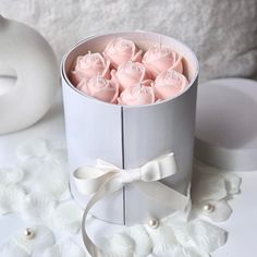 a box filled with pink roses on top of a table