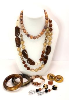 Vintage 70's to 90's Lucite Shades of Beige Brown Root Beer Coffee and Cream Necklace Earrings Bracelet Ring A curated collection of mix and match large earrings , chunky necklaces, beaded bracelet and bangle bracelets and one Lucite ring for good measure! 2 necklaces 2 bangle bracelets 2 pairs of earrings 1 beaded bracelet 1 ring These are vintage items, they have been cleaned, inspected and found to be in very good condition. Comes in a gift box ideal for gift giving and storage. Luxury Vintage Brown Necklace, Luxury Vintage Brown Necklaces, Collectible Brown Jewelry With Natural Stones, Retro Brown Jewelry For Gift, Vintage Brown Jewelry Gift, Retro Adjustable Brown Jewelry, Retro Brown Adjustable Jewelry, Brown Natural Stones Jewelry For Collectors, Retro Brown Beaded Jewelry