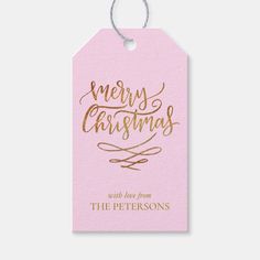 a pink christmas gift tag with gold lettering