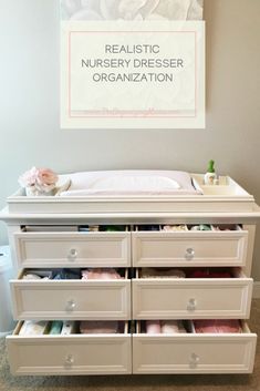 an organized nursery dresser with drawers in front of a sign that says realistic nursery dresser organization