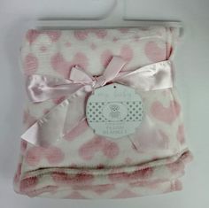 a pink and white blanket with a tag on it