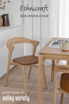 two wooden chairs sitting on top of a hard wood floor next to a white counter