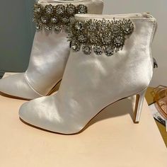 Ivory Satin Ankle Boots. Never Worn. Beautiful Crystal Embellishments Elegant Embellished Ankle-high Heels, White Embellished Boots With Round Toe, White Embellished Boots With Pointed Toe, Elegant White Round Toe Boots, White Almond Toe Boots For Party, Glamorous White Embellished Boots, White Almond Toe Party Boots, Elegant White Party Boots, White Low Heel Party Boots