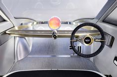 the interior of a futuristic vehicle with steering wheel and dashboard