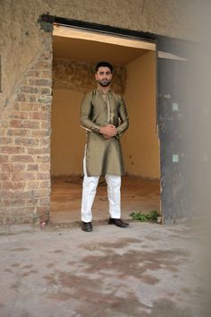 A unique dhani-colored silk kurta and plain cotton silk pajama with gold embroidery and motifs on the placket. Model wears Small/Medium. Wedding Semi-stitched Slub Silk Salwar Kameez, Semi-stitched Slub Silk Salwar Kameez With Handloom Details, Embroidered Semi-stitched Jamawar Sherwani, Semi-stitched Silk Salwar Kameez In Beige, Embroidered Semi-stitched Slub Silk Salwar Kameez, Silk Pajama, Silk Kurta, Gold Embroidery, Silk Pajamas