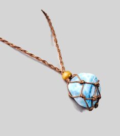 a blue and gold necklace with a wire wrapped around it