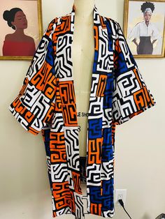 This tribal print duster kimono is made with the 100% cotton African wax  print.  It's a must have piece that can be styled in different ways, you can rock it over a fitted dress, skirt, shorts or pants.   Is a free size Black Printed Cotton Kimono, Black Cotton Kimono With Print, Black Cotton Printed Kimono, Black Oversized Cotton Kimono, Black Cotton Kimono For Festivals, Oversized Cotton Kimono With Kimono Sleeves, Casual Multicolor Print Kimono, Oversized Cotton Kimono For Festivals, Kimono With Vibrant Print For Festivals