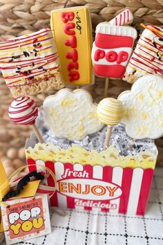 popcorn, marshmallows and lollipops on sticks in a basket