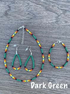 two pieces of beaded jewelry sitting on top of a wooden table