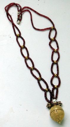 "An exclusive beautiful tribal pendant necklace from Rajasthan northern India. We sourced this piece of gem from a well known tribal family on the outskirts of Jodhpur. Solid well made 22 karat Gold sphere , the bottom half has tiny granulation ending with a tiny ball, the top half is quite shiny finish, set with a natural high grade Burmies Ruby and Pearl ,strung with Micro faceted spinal Ruby and gold beads. Ending with a beautiful golds clasp. Total length-54 cm(21\")we can adjust length, siz Temple Jewelry With Polished Round Beads, Kundan Temple Jewelry Necklace With Round Gemstone Beads, Temple Jewelry Style Kundan Necklace With Gemstones, Traditional Temple Necklace With Gemstones, Festive Gold Necklaces With Gemstone Beads, Festive Gold Necklace With Gemstone Beads, Traditional Gemstone Beaded Round Pendant, Traditional Round Pendant Jewelry With Gemstone Beads, Traditional Ruby Gemstone Necklace