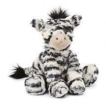 a zebra stuffed animal sitting on top of a white floor