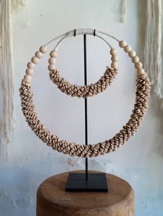 Handmade ceremonial Papua traditional Ornament from Indonesia. Made of white Shells . This Necklace is used in Papua for special rituals or ceremonies. Also is used as a payment between tribes. This beautiful piece is a very unique and powerful object in the Balinese culture. Size: L38, H38 high stand 47cm 0.8kg Perfect for elegant parties and all kind of Carnivals ! It can be wearied or used as a Decoration. You can buy with black metal stand You can buy without stand, you can hang it on the wa White Round Bead Necklaces For Traditional Ceremonies, White Round Beads Necklaces For Traditional Ceremonies, White Necklaces For Rituals And Festivals, Traditional Natural Beaded Necklace Gift, Traditional Natural Jewelry For Rituals, Traditional Natural Beaded Necklaces As Gift, Traditional Natural Beaded Necklaces For Gifts, Traditional Beaded Necklaces As Gift, Handmade White Jewelry For Traditional Ceremonies