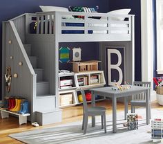 a child's bedroom with a loft bed, desk and bookshelf in it