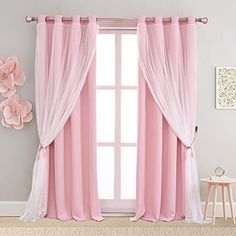 pink curtains with white drapes and flowers on the wall in front of a window