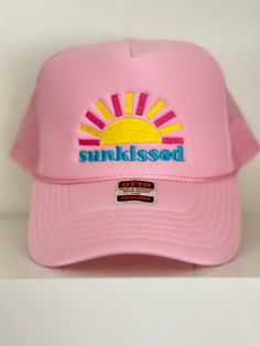 Embroidered "Sunkissed" Pink Trucker Hat Spring Beach Trucker Hat With Flat Brim, Summer Baseball Cap With Embroidered Logo And Flat Brim, Pink Summer Baseball Cap, Trendy Snapback Hat With Curved Brim For Beach Season, Summer Beach Dad Hat With Embroidered Logo, Beach Trucker Hat With Embroidered Logo And Curved Brim, Trucker Hat With Embroidered Logo For Beach, Trendy Summer Visor Dad Hat, Pink Snapback Hat With Curved Brim For Summer